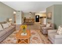 Open living room with tile floors, dining area, and kitchen in background at 9481 Highland Oak Dr # 609, Tampa, FL 33647