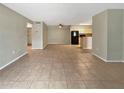 Spacious open floor plan with tile flooring throughout the living room and kitchen at 9481 Highland Oak Dr # 609, Tampa, FL 33647