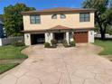 Beautiful home featuring a stone veneer, a two-car garage, and a well-manicured lawn at 659 Eunice Dr, Tarpon Springs, FL 34689