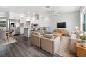 Open-concept living room showcasing modern design and seamless flow to kitchen with stainless steel appliances at 837 Dolphin Nw Ave, Port Charlotte, FL 33948