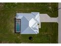 Aerial view of property showing the home's layout with pool and driveway, surrounded by green lawns at 261 Rotonda S Blvd, Rotonda West, FL 33947