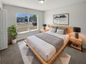 Cozy bedroom featuring a large window, plush bedding, and stylish nightstands at 8253 Penwood Dr, Port Richey, FL 34668