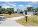 Single-story home featuring a well-kept lawn, mailbox, and driveway leading to an attached garage at 2239 Worrington St, Sarasota, FL 34231
