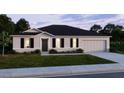 Charming single-Gathering home with a well-maintained lawn, neutral tones, and classic architectural design at 25416 Jubal St, Punta Gorda, FL 33955