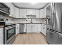 Bright kitchen featuring stainless steel appliances and modern white cabinetry at 5004 E Seneca Ave, Tampa, FL 33617