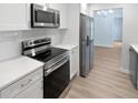 Modern kitchen featuring stainless steel appliances, subway tile backsplash, and quartz countertops at 5028 Oakshire Dr, Tampa, FL 33625