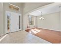 Inviting foyer boasts tile flooring, a decorative chandelier, and natural light at 11818 Gilmerton Dr, Riverview, FL 33579