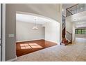 Elegant living area featuring wood floors, arched entryway, and staircase at 11818 Gilmerton Dr, Riverview, FL 33579