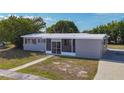 Attractive single-story home with a screened front entry, red shutters, and a fresh white roof at 22131 Bahama Ave, Port Charlotte, FL 33952