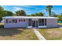 Inviting single-story home showcasing a screened entryway, classic shutters, and tidy landscaping at 22131 Bahama Ave, Port Charlotte, FL 33952