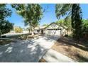 A cozy single-Gathering home with a two-car garage, complemented by verdant trees at 3419 Pleasant Lake Dr, Tampa, FL 33618