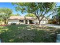 Inviting single-Gathering home showcasing a lush front yard and attached two-car garage at 3419 Pleasant Lake Dr, Tampa, FL 33618