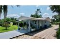Home featuring a covered carport and driveway, complemented by mature landscaping at 5213 Keene Dr, Plant City, FL 33566