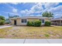 Charming single-story home with a well-maintained lawn and welcoming curb appeal at 1409 N Garden Ave, Clearwater, FL 33755