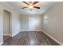 Inviting living room featuring wood flooring, neutral walls, and a bright white front door at 1409 N Garden Ave, Clearwater, FL 33755