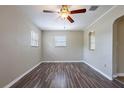 Bright living room with modern ceiling fan, neutral walls, and stylish wood flooring at 1409 N Garden Ave, Clearwater, FL 33755