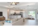 Open-concept living space featuring a spacious kitchen, dining area, and comfortable seating at 4150 Windsong Ave, North Port, FL 34287