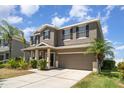 Inviting home featuring a manicured lawn, two car garage, and a well maintained driveway at 541 Vista Ridge Dr, Ruskin, FL 33570