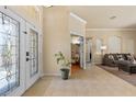 Bright foyer with tile flooring, decorative glass front doors, and an open view to the living room at 2818 Mossy Timber Trl, Valrico, FL 33596