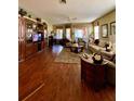 The large living room features hardwood floors and plenty of natural light at 30442 Lettingwell Cir, Wesley Chapel, FL 33543