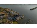 Stunning aerial shot showcasing the waterfront home with a pool and dock, set against a backdrop of scenic islands at 3310 Sunset N Dr, St Petersburg, FL 33710