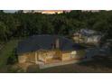 Charming single-story home featuring a dark roof and a lush, green landscape at 5404 Carso Ter, North Port, FL 34286