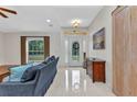Bright foyer with tiled floors, front door, and natural light at 5404 Carso Ter, North Port, FL 34286