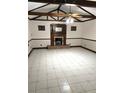 Spacious living room with a fireplace, tile flooring, and wood-beam ceiling at 8641 May Cir, Tampa, FL 33614