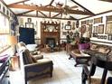 Inviting living room with a beamed ceiling, fireplace, and an array of decorative elements at 8641 May Cir, Tampa, FL 33614