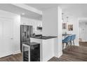 Condo kitchen with stainless appliances, granite counters, white cabinetry and stylish lighting at 1238 E Kennedy Blvd # 802, Tampa, FL 33602