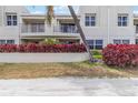 Attractive residential building featuring balconies, vibrant red shrubbery, and well-kept landscaping at 6131 Bahia Del Mar Blvd # 139, St Petersburg, FL 33715