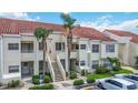 Apartment complex with parking, tiled roofs and palm trees at 6131 Bahia Del Mar Blvd # 139, St Petersburg, FL 33715