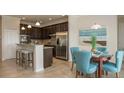 Cozy dining area adjacent to the kitchen with stylish furnishings and natural light at 6179 Notre Dame Ter, North Port, FL 34291