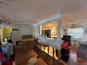 Interior view showcasing an open-concept living space with hardwood floors and kitchen view at 560 7Th S St, Safety Harbor, FL 34695