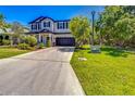 Charming two-story home with a well-maintained lawn and a spacious driveway leading to a two-car garage at 5703 New Paris Way, Ellenton, FL 34222
