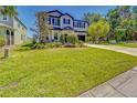 Beautiful two-story home featuring manicured landscaping and a wide green lawn at 5703 New Paris Way, Ellenton, FL 34222