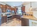 Well-equipped kitchen with stainless steel appliances, granite countertops and ample cabinet space at 5703 New Paris Way, Ellenton, FL 34222