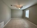 Bedroom offering neutral walls, tile flooring and natural light from the large window at 13344 Great Plains S Dr, Riverview, FL 33579