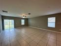 Spacious living room featuring neutral walls and tile flooring, bathed in natural light at 13344 Great Plains S Dr, Riverview, FL 33579