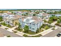 A high angle view of neighborhood featuring charming light blue homes near a pond and lake at 283 Saint Lucia Dr # 202, Bradenton, FL 34209