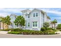 Beautiful view of a two-story home featuring light blue siding and manicured landscaping on a sunny day at 283 Saint Lucia Dr # 202, Bradenton, FL 34209