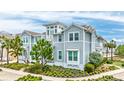 Beautiful view of a two-story home featuring light blue siding and manicured landscaping on a sunny day at 283 Saint Lucia Dr # 202, Bradenton, FL 34209