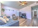 Cozy living room features hardwood floors, a ceiling fan, and stylish furniture at 505 Hedge Row Rd, Brandon, FL 33510