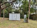 Backyard shed featuring a metal container, providing ample outdoor storage space and convenience at 4213 Temple Heights Rd, Tampa, FL 33617