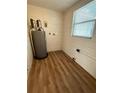 Laundry area with new flooring, water heater and window at 4617 John Bell Jr Dr, Tampa, FL 33610