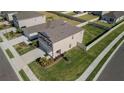 Aerial view of a well-maintained home with a spacious, green lawn and a classic suburban setting at 6438 Milestone Loop, Palmetto, FL 34221