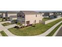Expansive lawn surrounds this home with neutral siding, complemented by well-maintained landscaping at 6438 Milestone Loop, Palmetto, FL 34221