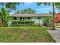 Charming single-story home featuring a well-manicured lawn, front porch and tidy landscaping at 9503 Alice Ln, Riverview, FL 33578