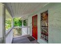 Inviting covered porch with a decorative front door and etched glass sidelight for added curb appeal at 9503 Alice Ln, Riverview, FL 33578