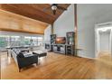 Spacious living room boasts a vaulted wood ceiling, fireplace, and abundant natural light at 9503 Alice Ln, Riverview, FL 33578